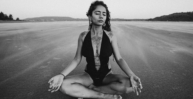 woman meditating - accomplished pose