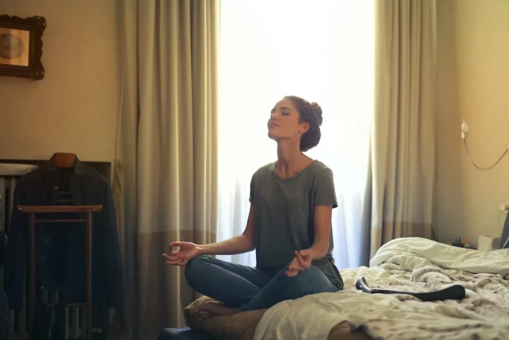 Woman meditating in room