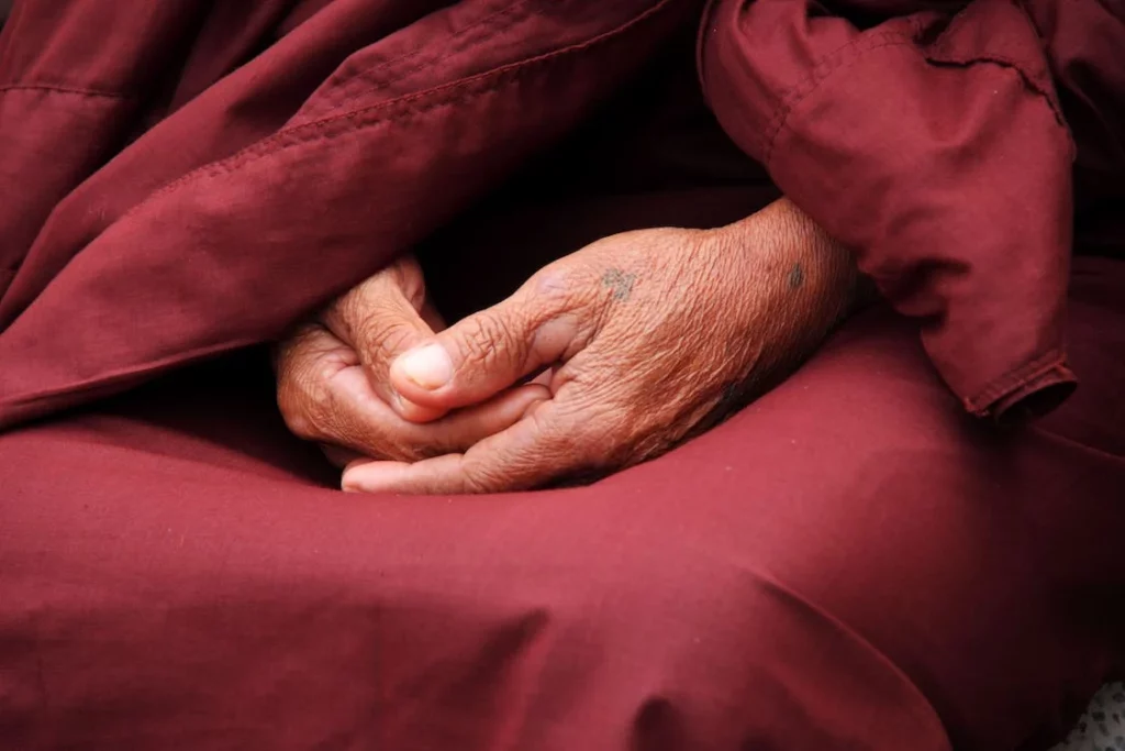 meditating hands of buddhist monk